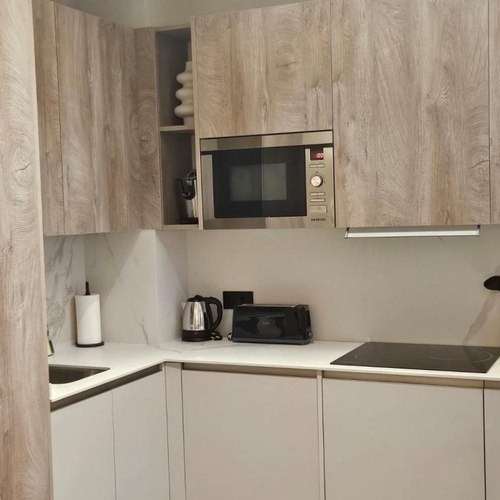 a kitchen with stainless steel appliances and wooden cabinets