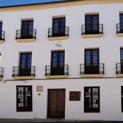 a white building with balconies and a sign that says museo