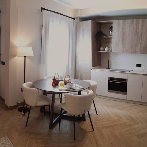 a kitchen and dining area with a table and chairs