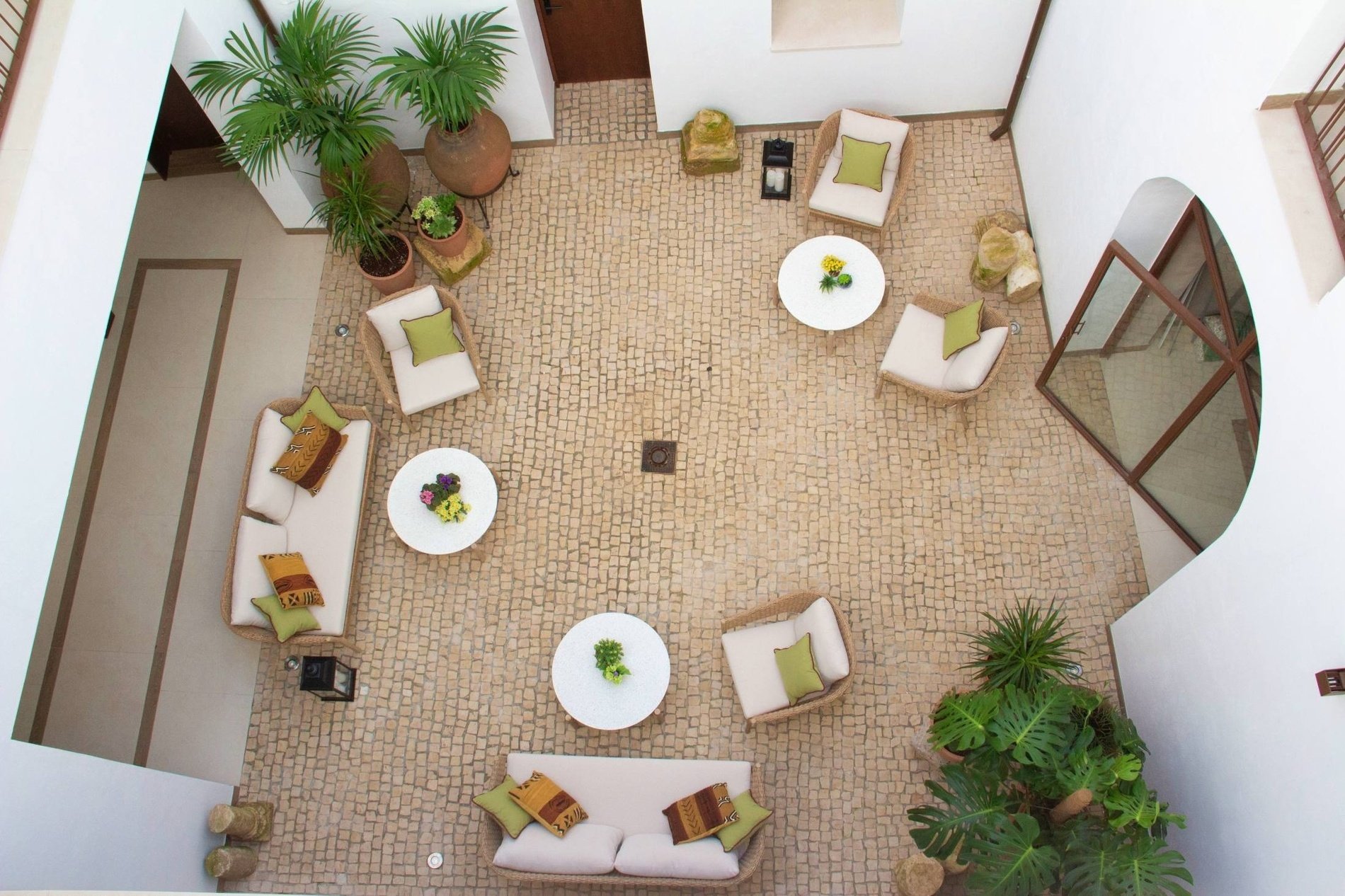 an aerial view of a courtyard with a couch and chairs