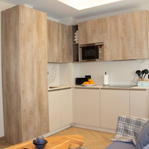 a kitchen with wooden cabinets and a microwave