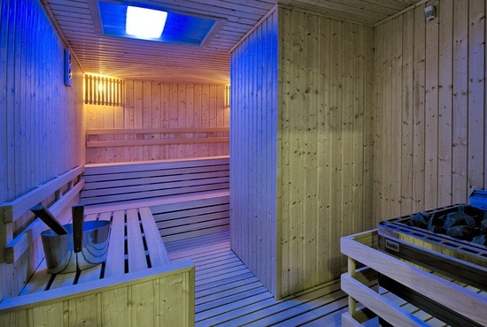a sauna with a blue light on the ceiling