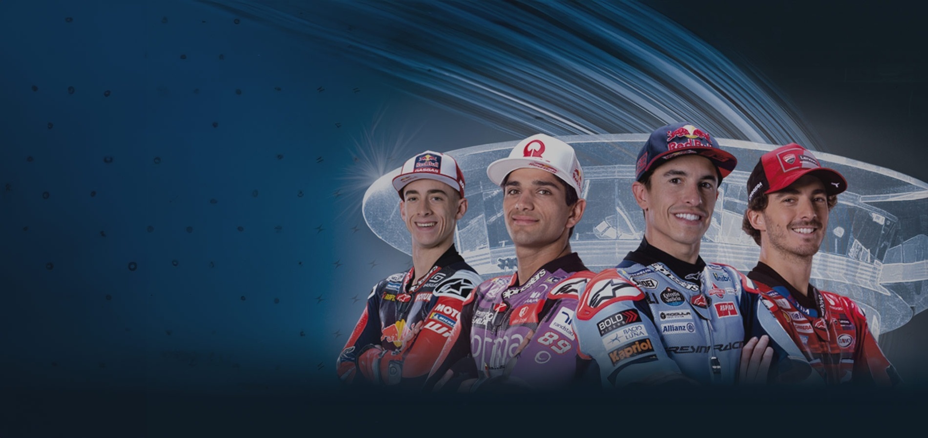 four motorcycle racers standing next to each other with one wearing a red bull hat