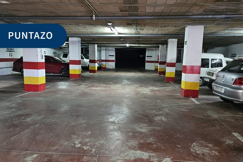 a parking garage with a blue sign that says puntazo