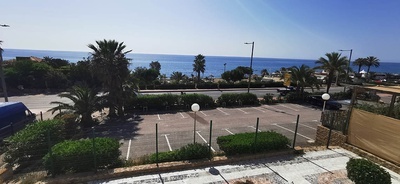 a view of the ocean from a parking lot