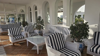 a room with striped chairs and a sign that says ' coca cola ' on it - 