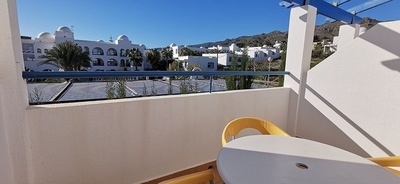 a balcony with a view of a white building