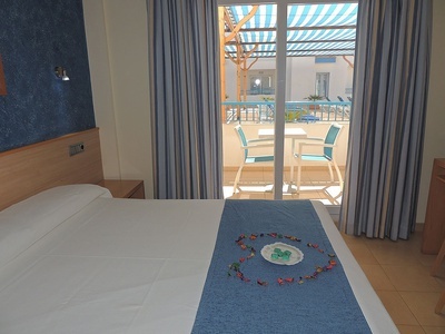 a hotel room with a sliding glass door leading to a balcony