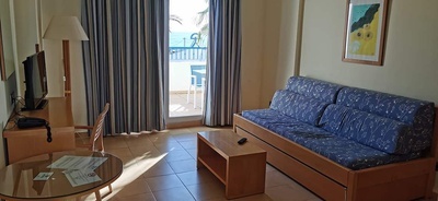 a hotel room with a couch and a table