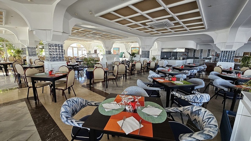 a restaurant with tables and chairs set up for dinner