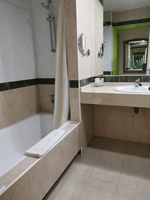 a bathroom with a bathtub sink and mirrors