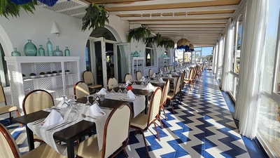 un restaurante con mesas y sillas y un suelo azul y blanco - 