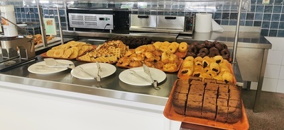 a variety of baked goods are displayed on a counter - 