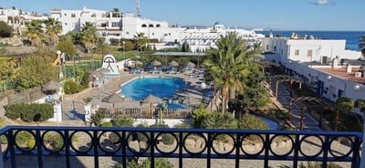 an aerial view of a hotel with a large swimming pool