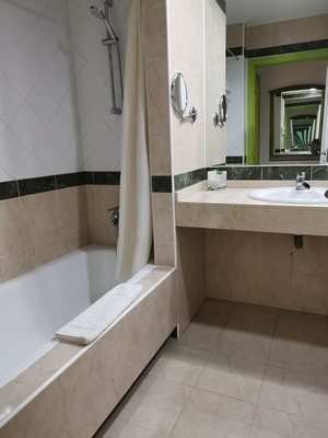 a bathroom with a bathtub sink and mirrors