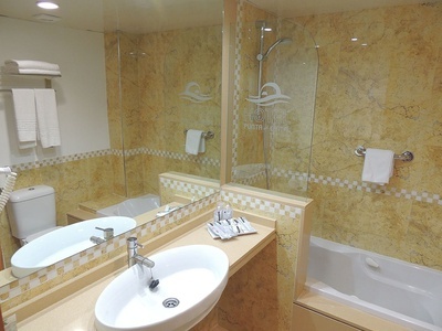 a bathroom with the word hotel on the wall