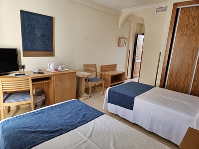 a hotel room with two beds and a desk