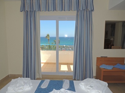 a hotel room with a view of the ocean
