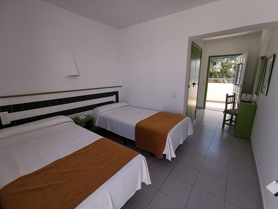 a hotel room with two beds and a chair