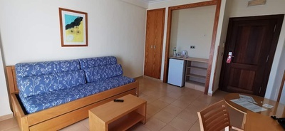 a hotel room with a couch and a table