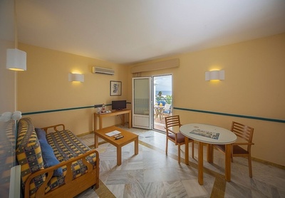 a living room with a couch a table and chairs