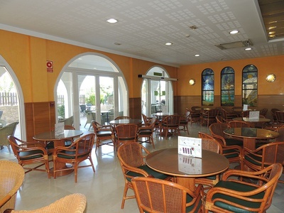un restaurante con muchas mesas y sillas - 