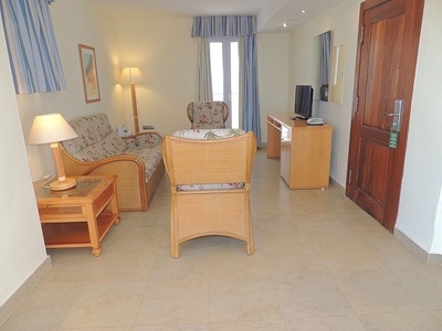 a living room with a couch a chair and a television