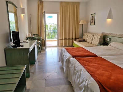 a hotel room with two beds and a couch