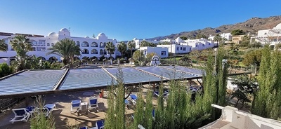 a white building with a blue and white striped awning
