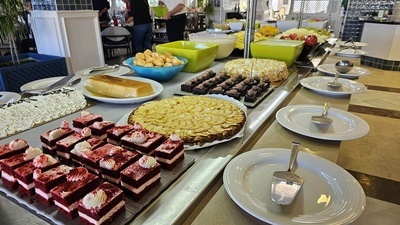 a variety of desserts are displayed on a buffet line - 