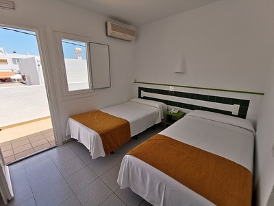 a hotel room with two beds and a window