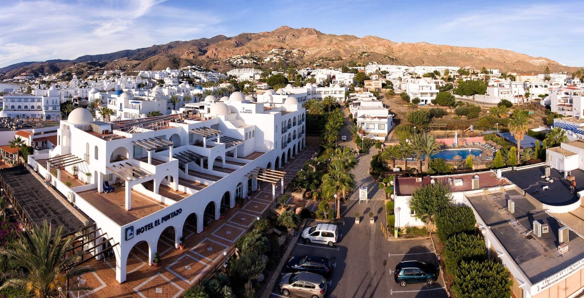 an aerial view of hotel el principe with mountains in the background