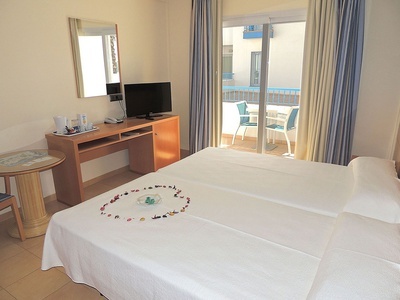 a hotel room with a bed and a desk