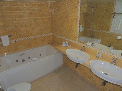 a bathroom with a jacuzzi tub and two sinks