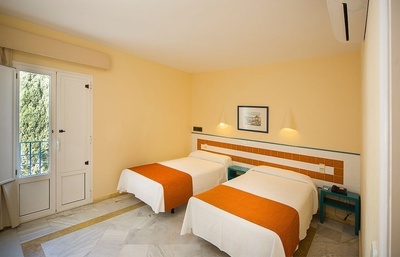 a hotel room with two beds and a picture on the wall