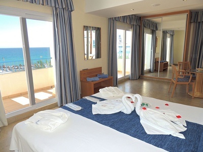a hotel room with a swan shaped towel on the bed
