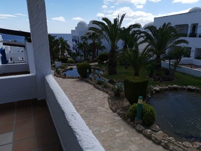 a walkway with a pond in the middle of it