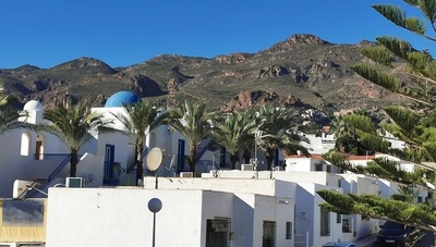 a white building with a blue dome on top of it