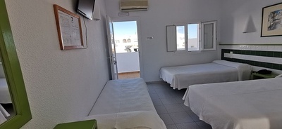 a hotel room with two beds and a couch