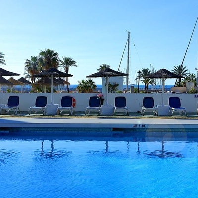 a swimming pool with chairs and umbrellas and the number 2 on the side