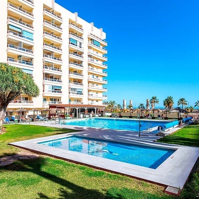 a large building with a swimming pool in front of it
