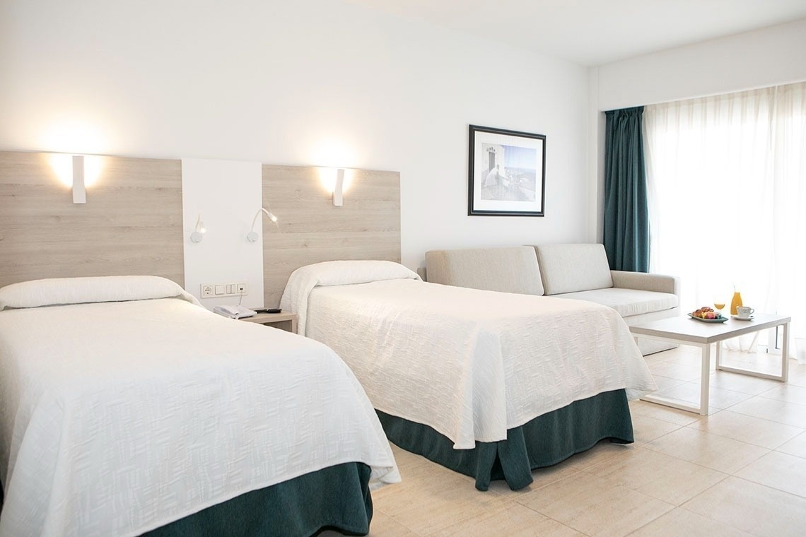 a hotel room with a couch and a bed