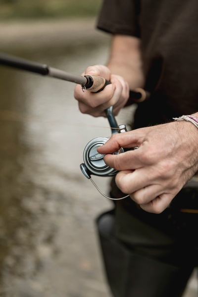 a person is holding a fishing rod with a reel that says ' spinning ' on it