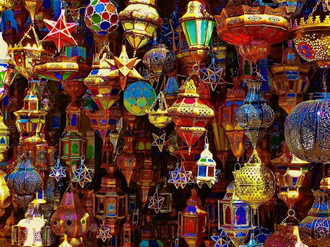 a bunch of colorful lanterns hanging from the ceiling
