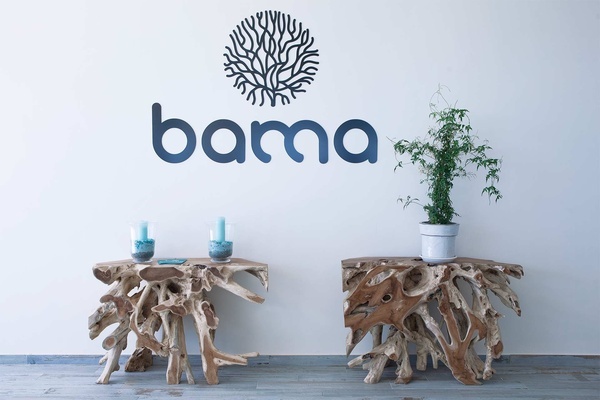 two wooden tables in front of a wall that says bama