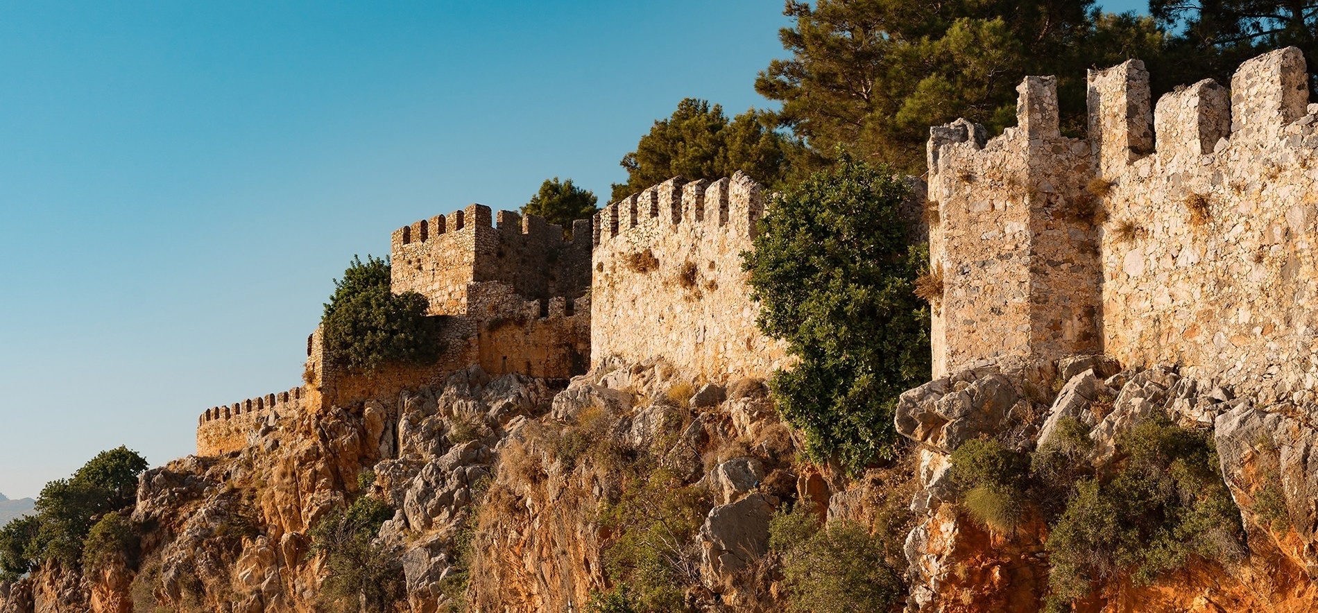 a stone wall on top of a rocky hillside