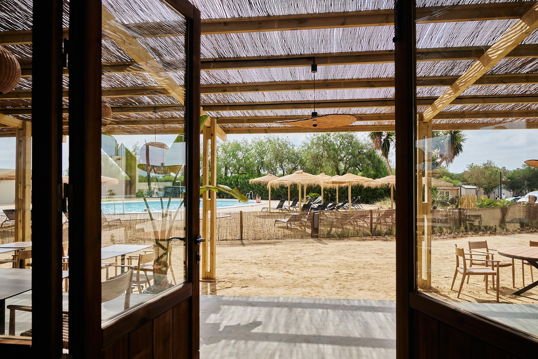 a view of a swimming pool through a glass door