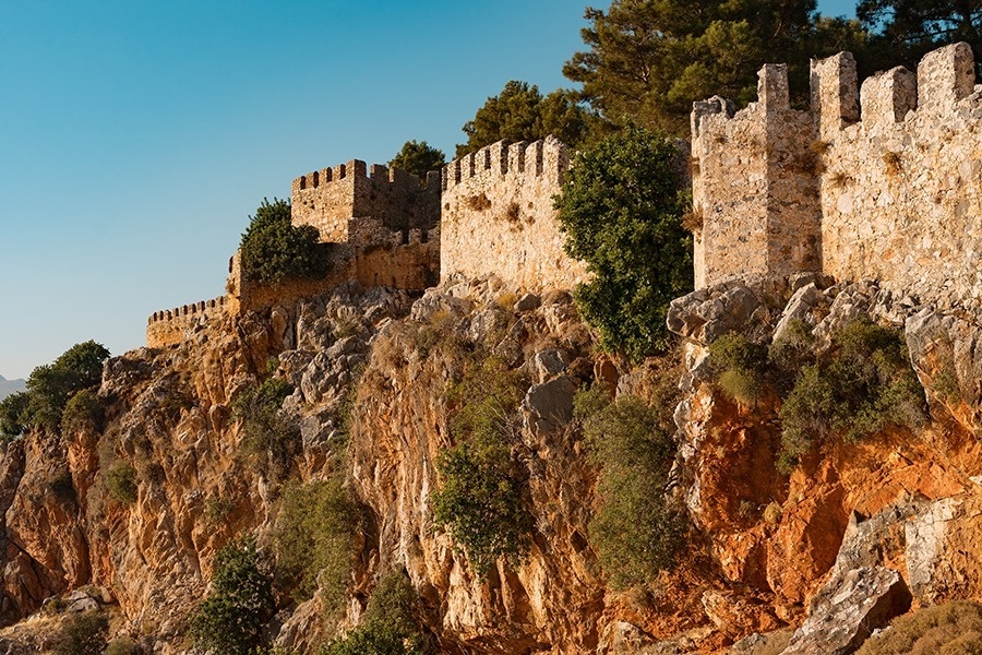 a stone wall on top of a rocky hillside