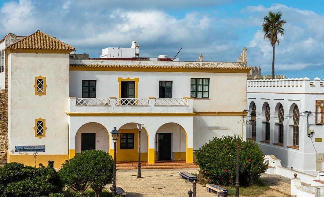 a white and yellow building with a sign that says 
