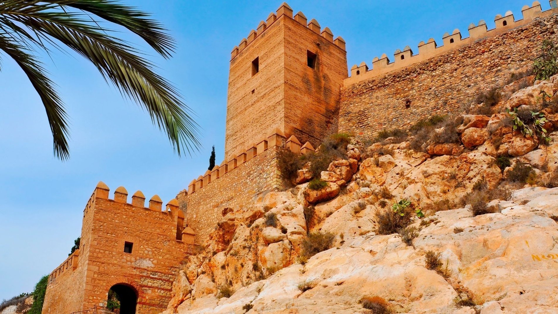 a stone wall with a tower on top of it